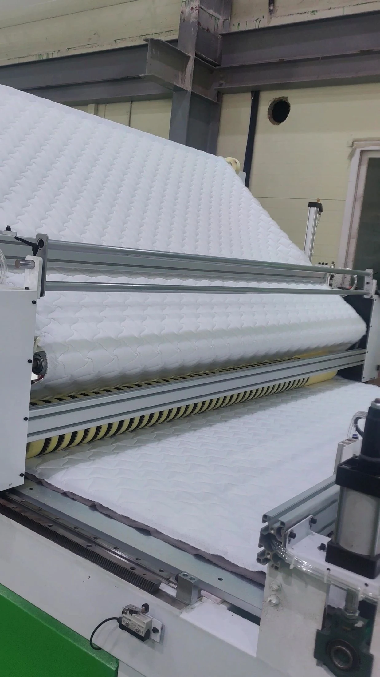 Fabric passing through the machine feeding rollers