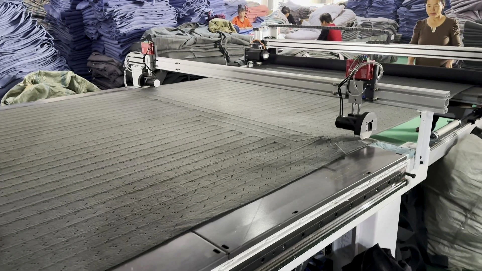 Heating wire being laid automatically on blanket material