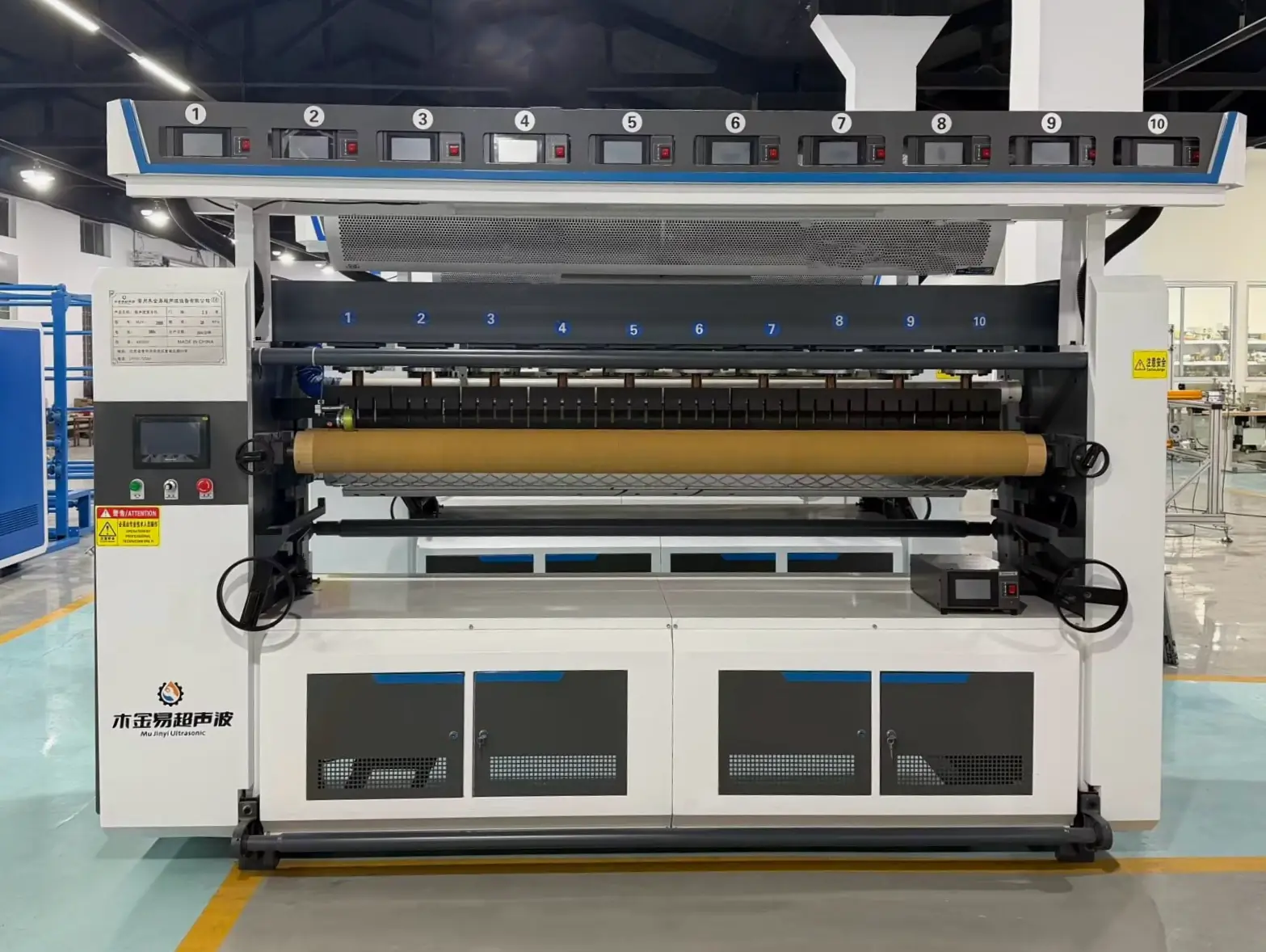 Front view of a reference ultrasonic laminating machine with patterned roller and multiple ultrasonic stations